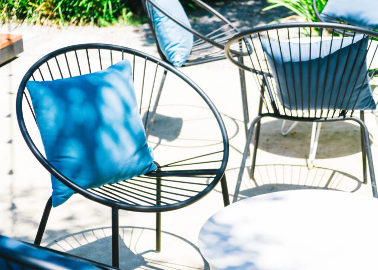 Patio with Pillow on chair and table set in outdoor garden