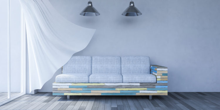 3ds rendered image of living room which have cracked concrete wall and old wooden floor and colorful old wooden sofa set, White fabric curtains being blown by wind from the sea