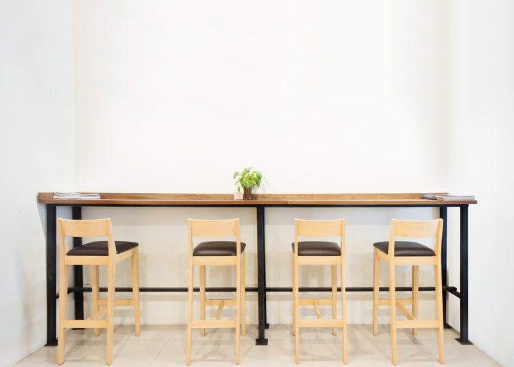 Counter in cafe bar with white wall empty space.