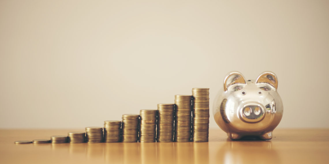 Piggy bank gold color and stack of money, save money