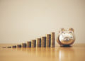 Piggy bank gold color and stack of money, save money