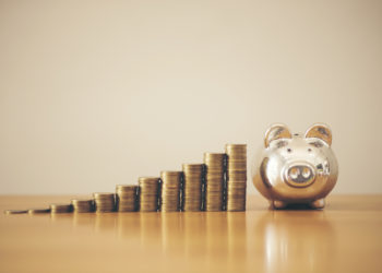 Piggy bank gold color and stack of money, save money