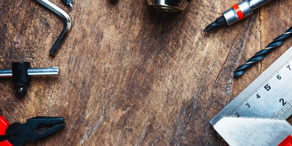 Different construction tools with Hand tools for home renovation on wooden board maintenance and reparing concept.