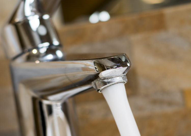 Faucet with scale. Bathroom scene