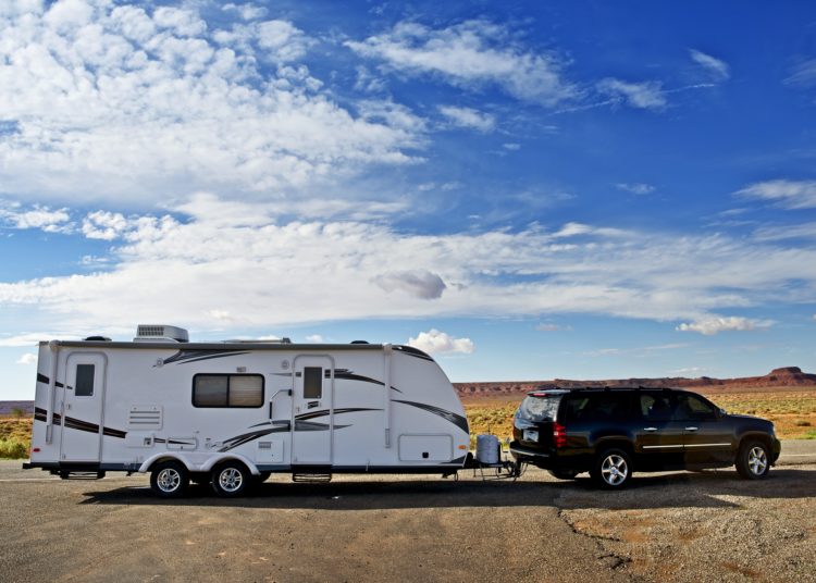 RV Trailer Journey. Travel Trailer Pulling by Large Sport Utility Vehicle in Arizona USA. RV Adventures. Recreation Photo Collection.