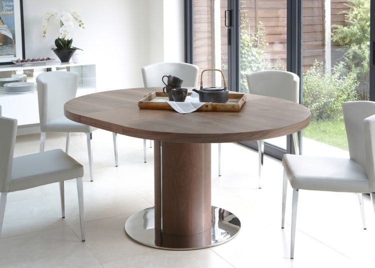 Round walnut dining table with chairs