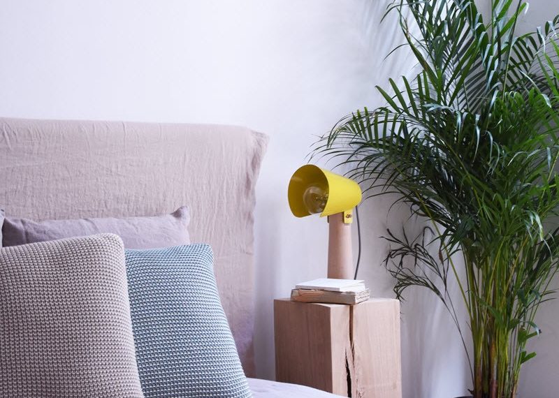 Modern bedroom with yellow modern light on the cupboard