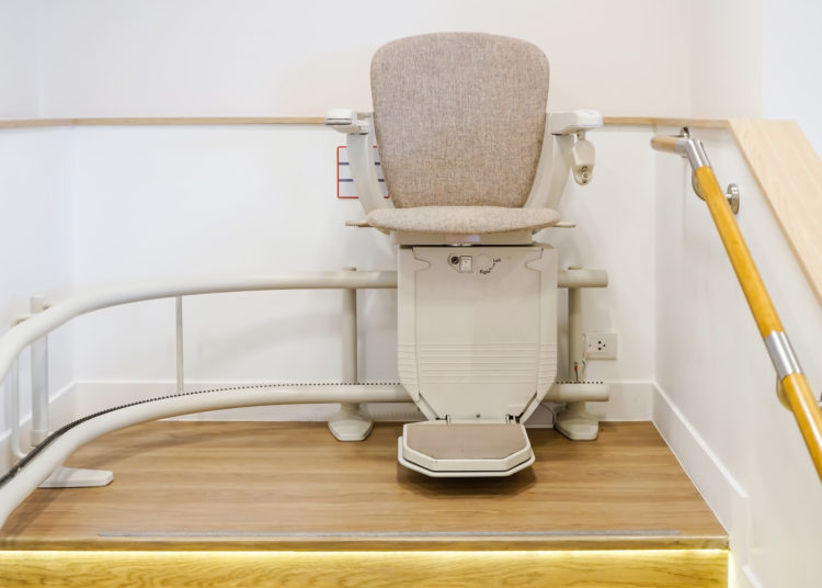 Automatic stair lift on staircase for elderly people and disabled persons