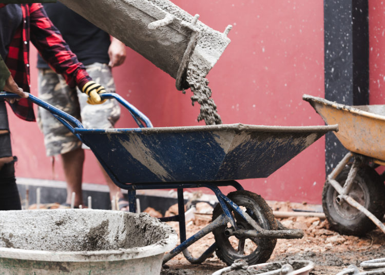 industrial construction labor work concrete mix with cart