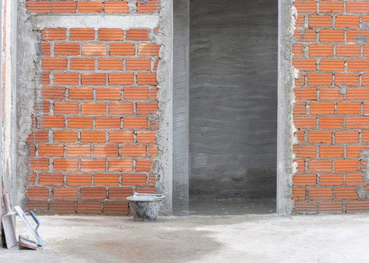 Red brick wall with doorway in residential building construction site