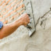 Builders are plastering the walls of the house with neatness. Have professional skills and high working experience. Concept of construction business.