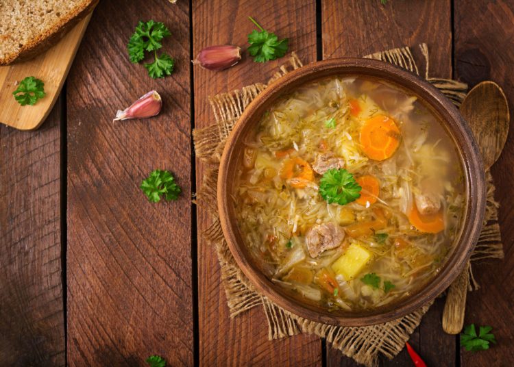 Traditional Russian soup with cabbage - sauerkraut soup. Flat lay. Top viewTraditional Russian soup with cabbage - sauerkraut soup. Flat lay. Top view