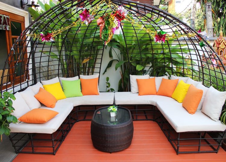 Elegant patio furniture with colorful cushions.