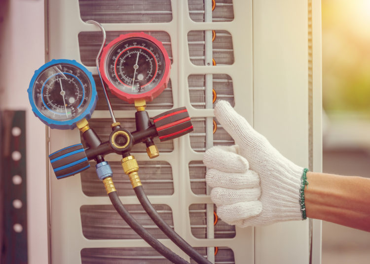 Close up of Air Conditioning Repair, repairman on the floor fixing air conditioning system