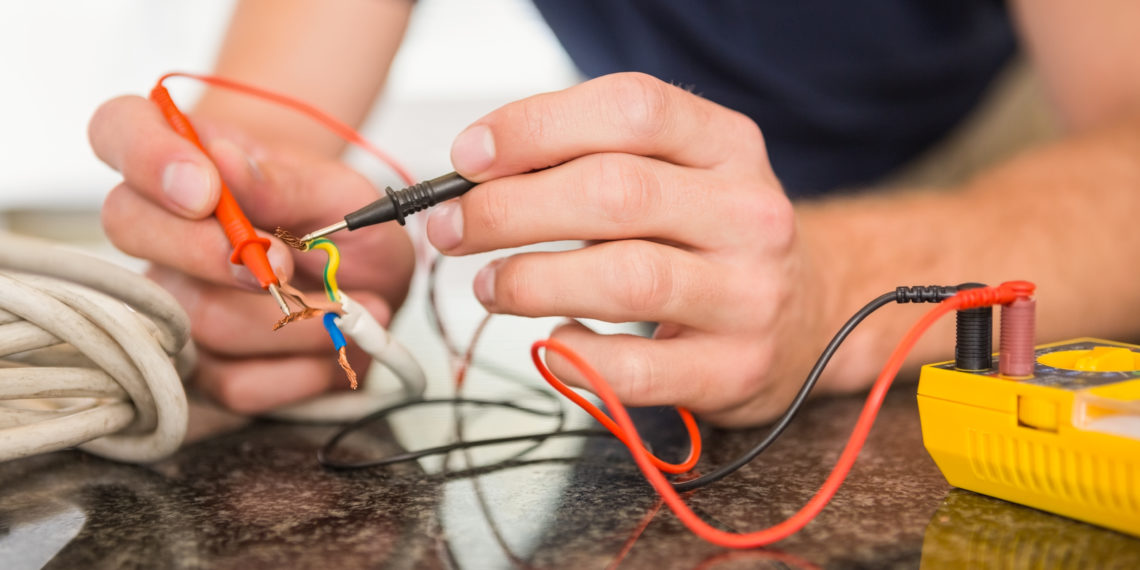 Construction worker working on cables in the kitchen