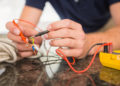 Construction worker working on cables in the kitchen
