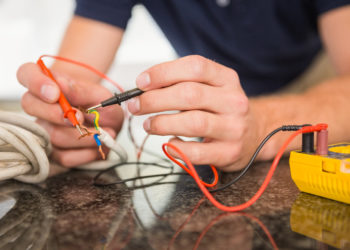 Construction worker working on cables in the kitchen