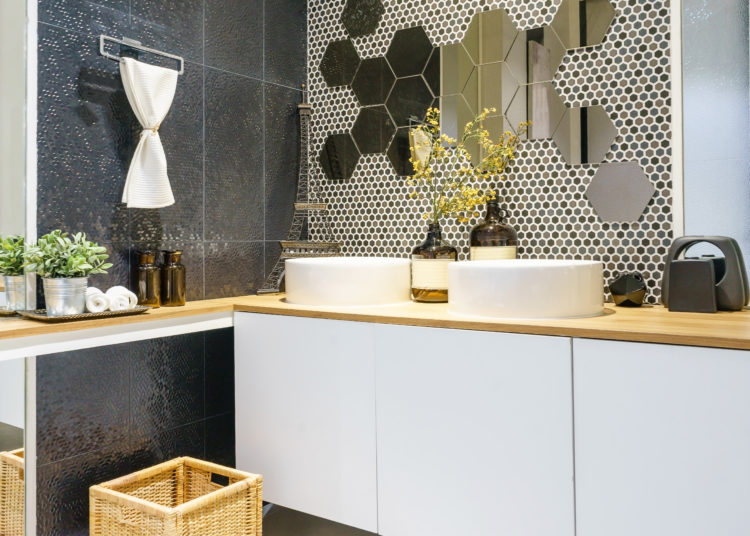 Modern spacious bathroom with bright tiles with toilet and sink.