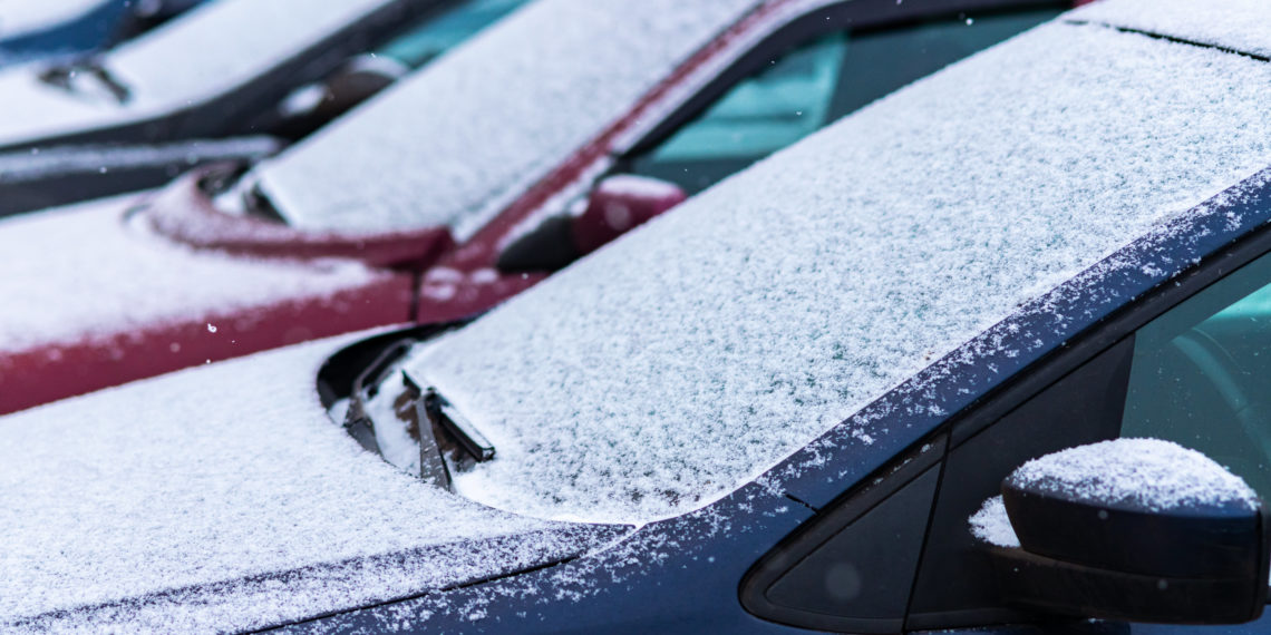 Snow covered cars in the parking, close up. Antifreeze was not used. Vehicles in snow. Winter time is coming. Bad weather conditions