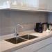Minimalistic kitchen corner with appliances. Hotel room facilities including kettle, multicooker, coffeemaker, toaster, dish. City apartment concept