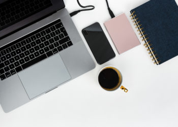 Pink external hard disk connecting to a laptop