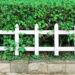 White fence and green plants