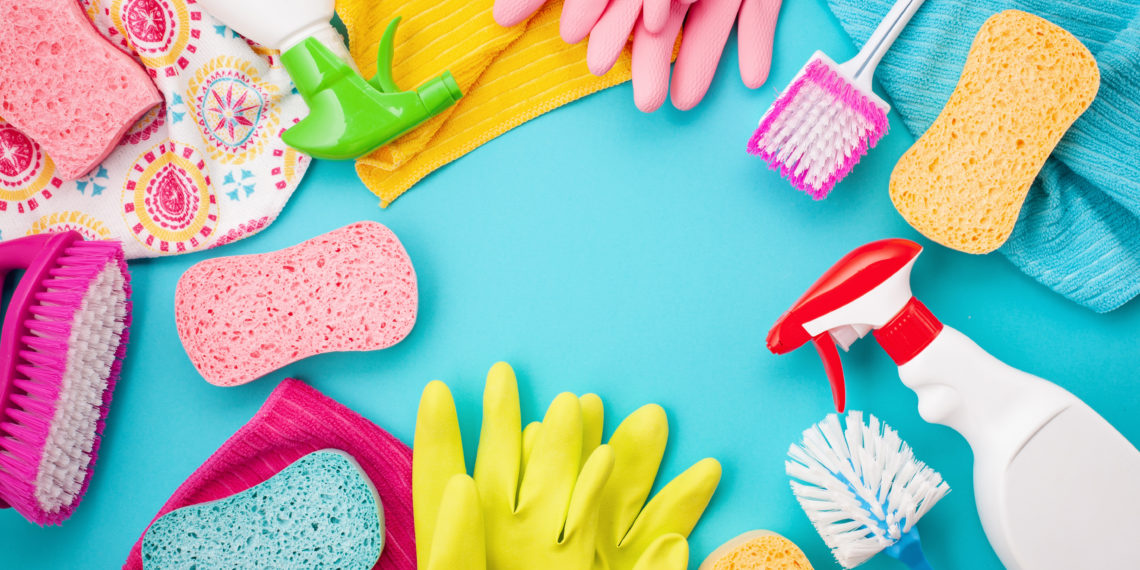 Detergents and cleaning accessories in pastel color. Cleaning service, small business idea, spring cleaning concept. Flat lay, Top view.