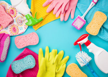 Detergents and cleaning accessories in pastel color. Cleaning service, small business idea, spring cleaning concept. Flat lay, Top view.