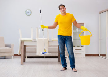 Man cleaning the house helping his wife
