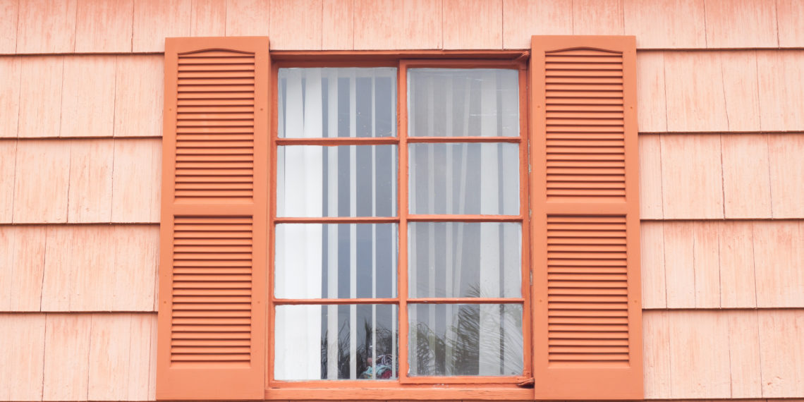 Vintage window with orange tone wall