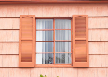 Vintage window with orange tone wall