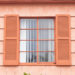 Vintage window with orange tone wall
