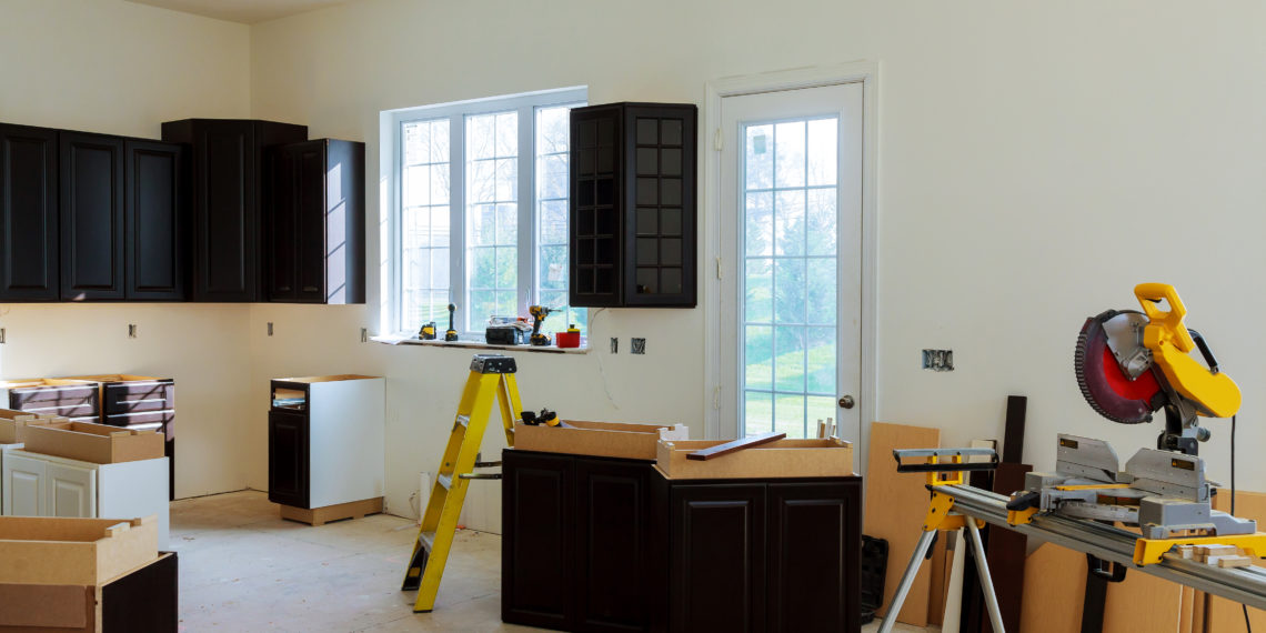 Installing new induction hob in modern kitchen cabinets installation