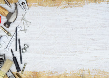 Construction tools DIY background concept. Tools shop service banner. Set of tools supplies for house repair builder on white painted wood background.