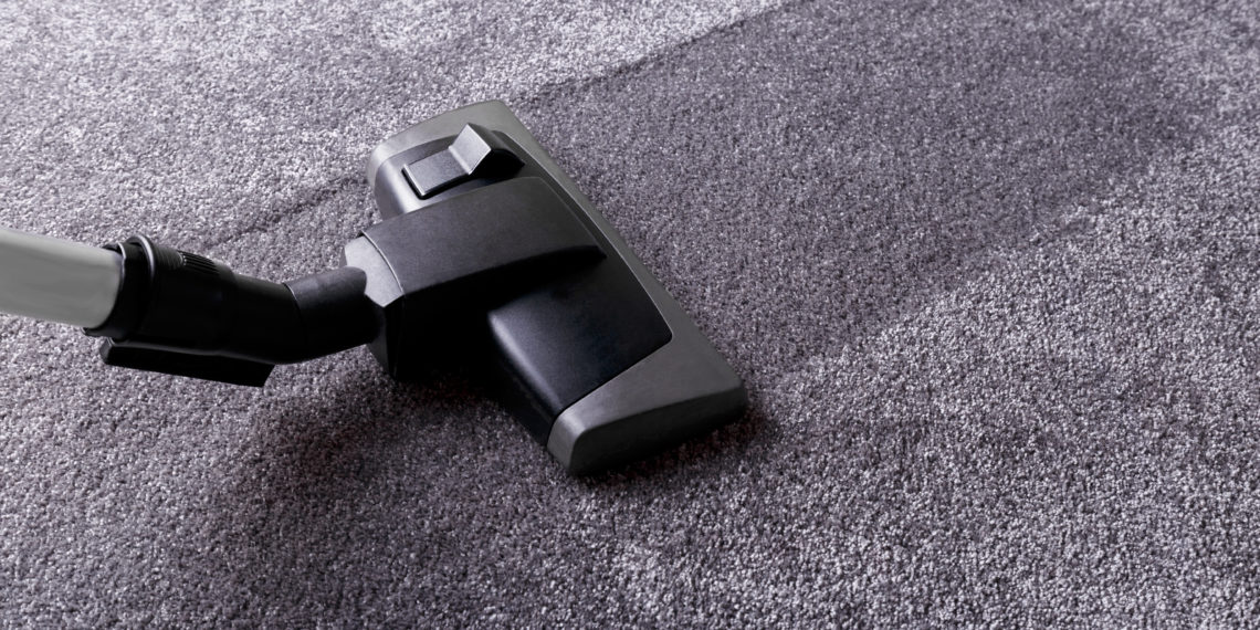Grey carpet texture and cleaner, close up, indoors interior design