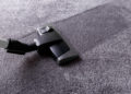 Grey carpet texture and cleaner, close up, indoors interior design