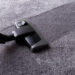 Grey carpet texture and cleaner, close up, indoors interior design