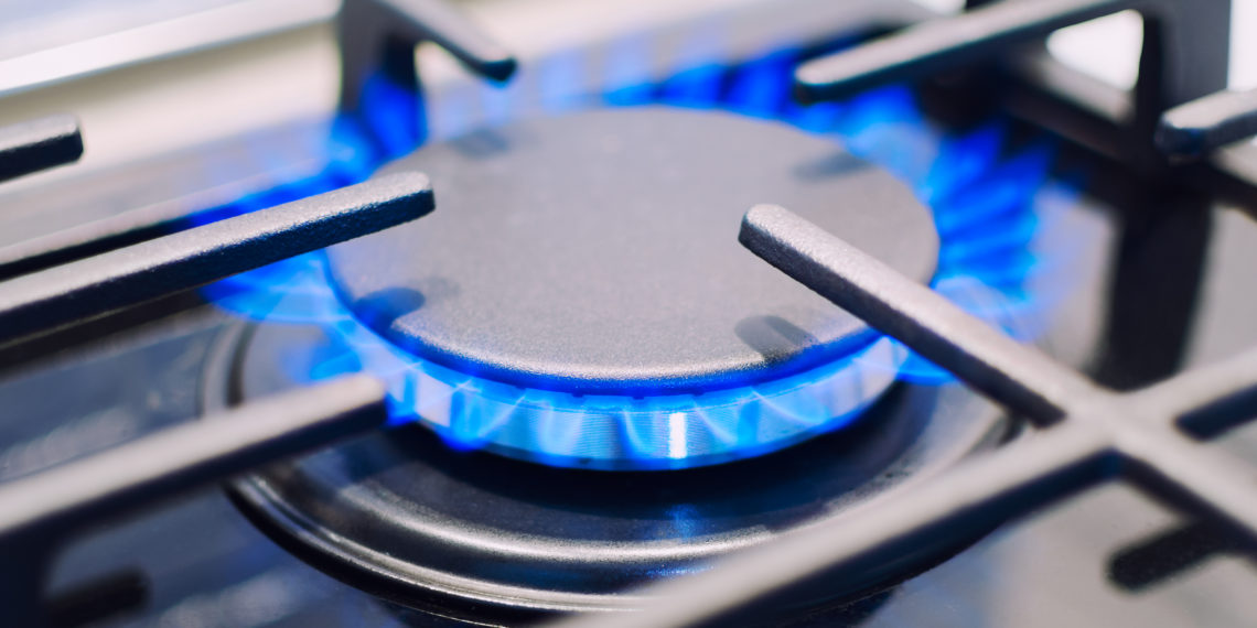 Burning gas burner on the stove. Photo with shallow depth of focus.