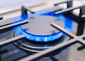 Burning gas burner on the stove. Photo with shallow depth of focus.