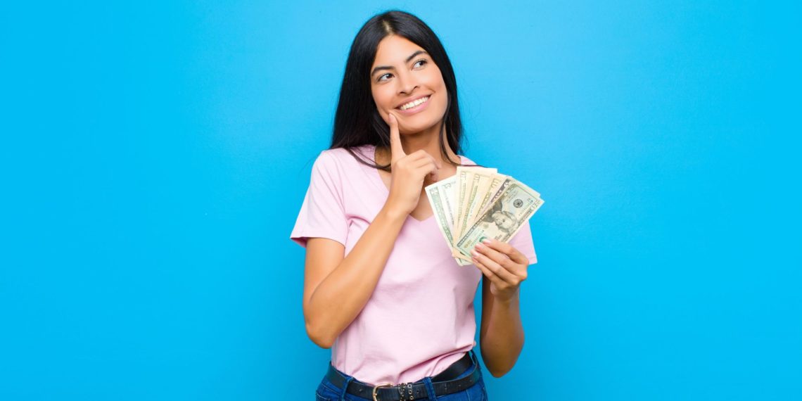 smiling happily and daydreaming or doubting, looking to the side