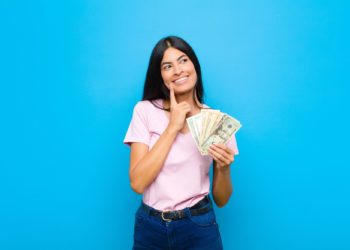 smiling happily and daydreaming or doubting, looking to the side