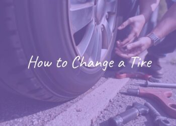 Close-up of hands changing a car tire on the roadside, spare tire and tools scattered around, realistic, daytime.