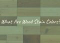 Variety of wood stain colors on different wood grains, showcasing natural textures and hues, realistic.