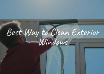 A person cleaning exterior windows with a squeegee, sunny day, clear blue sky, realistic.