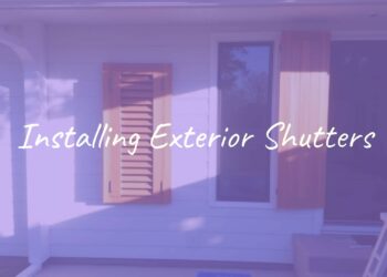 A house with freshly installed wooden exterior shutters, sunny day, clean and professional look, modern home exterior, tools nearby.